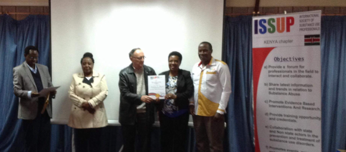 Mr. Oloo (President), Dr. Richard Gakunju,Dr William Sinkele and Dr Dr. Beatrice Kathungu issuing membership certificate to Professor Catherine Gachutha.