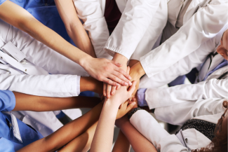 healthcare workers with hands together